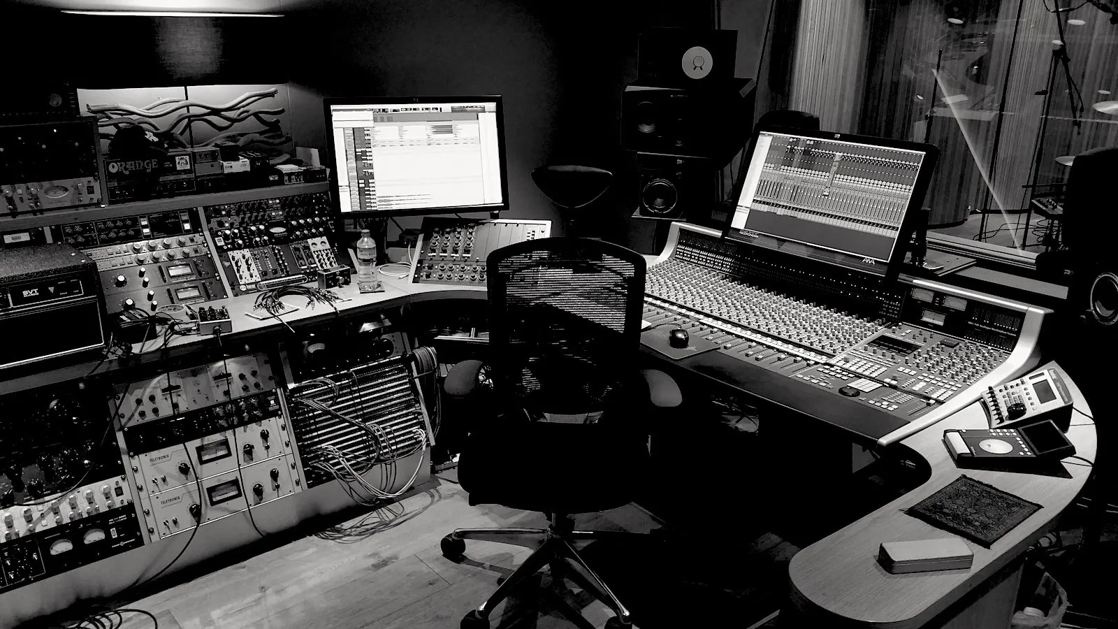The A Sharp control room at work in black and white - outboard racks, console and screens